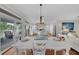 White farmhouse dining table with bench seating in bright dining area at 12116 Lagoon Ln, Treasure Island, FL 33706