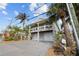 Two-story house with two-car garage and nicely landscaped front yard at 12116 Lagoon Ln, Treasure Island, FL 33706