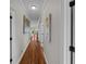 Bright hallway with hardwood floors and artwork at 12116 Lagoon Ln, Treasure Island, FL 33706