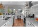 Bright kitchen with white cabinets, granite countertops, and access to a balcony at 12116 Lagoon Ln, Treasure Island, FL 33706