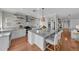 Modern white kitchen with stainless steel appliances and large island at 12116 Lagoon Ln, Treasure Island, FL 33706