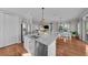 Open concept kitchen with island, stainless steel appliances, and hardwood floors at 12116 Lagoon Ln, Treasure Island, FL 33706