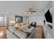 Bright living room features comfortable seating, a large TV, and hardwood floors at 12116 Lagoon Ln, Treasure Island, FL 33706