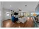 Spacious living area with hardwood floors, comfy seating, and built-in shelving at 12116 Lagoon Ln, Treasure Island, FL 33706
