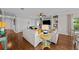 Open concept living room with built-in shelving and hardwood floors at 12116 Lagoon Ln, Treasure Island, FL 33706