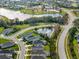 Aerial view of a community with lake, park, and residential homes at 12739 Rainwashed Loop, Parrish, FL 34219