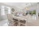 Light-filled dining room with seating for six and view to living room at 12739 Rainwashed Loop, Parrish, FL 34219