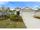 Single-Gathering house with a two-car garage and lush landscaping at 12739 Rainwashed Loop, Parrish, FL 34219