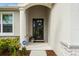 Inviting front entry with a charming porch and landscape at 12739 Rainwashed Loop, Parrish, FL 34219