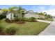 Landscaped front yard with palm trees and driveway at 12739 Rainwashed Loop, Parrish, FL 34219
