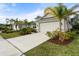 Well-maintained lawn and driveway with palm trees at 12739 Rainwashed Loop, Parrish, FL 34219