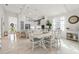 Bright, spacious kitchen and dining area with white cabinets and modern appliances at 12739 Rainwashed Loop, Parrish, FL 34219