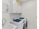 Laundry room with white cabinets, washer, and dryer at 12739 Rainwashed Loop, Parrish, FL 34219
