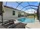 Inviting pool area with covered patio and lounge chairs at 12739 Rainwashed Loop, Parrish, FL 34219