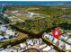 Aerial view of waterfront property, showcasing canal access and nearby community at 170 S Saint Thomas Cir, Apollo Beach, FL 33572