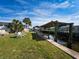 Backyard with canal view, patio furniture, and grassy area at 170 S Saint Thomas Cir, Apollo Beach, FL 33572