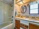 Bathroom with double vanity, shower/tub combo, and vintage tile at 170 S Saint Thomas Cir, Apollo Beach, FL 33572
