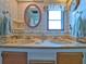 Clean bathroom with double sinks and a vintage style at 170 S Saint Thomas Cir, Apollo Beach, FL 33572