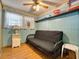 Small bedroom with a futon and light blue walls at 170 S Saint Thomas Cir, Apollo Beach, FL 33572