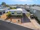 Single-wide manufactured home with carport and golf cart at 170 S Saint Thomas Cir, Apollo Beach, FL 33572