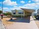 Front view of yellow mobile home with carport and landscaping at 170 S Saint Thomas Cir, Apollo Beach, FL 33572