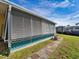 Side of mobile home with aluminum hurricane shutters and walkway at 170 S Saint Thomas Cir, Apollo Beach, FL 33572