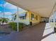Side view of mobile home with covered patio and landscaping at 170 S Saint Thomas Cir, Apollo Beach, FL 33572