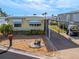 Single-wide manufactured home with carport and landscaped yard at 170 S Saint Thomas Cir, Apollo Beach, FL 33572