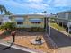 Single-wide manufactured home with carport and landscaped yard at 170 S Saint Thomas Cir, Apollo Beach, FL 33572
