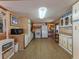 Bright kitchen features wood cabinets, laminate flooring, and white appliances at 170 S Saint Thomas Cir, Apollo Beach, FL 33572