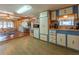 Open kitchen with light wood cabinets, and views into the dining area at 170 S Saint Thomas Cir, Apollo Beach, FL 33572