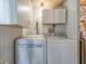 Clean laundry room with washer, dryer, and cabinets at 170 S Saint Thomas Cir, Apollo Beach, FL 33572