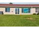 Private backyard with sliding glass doors and lush green grass at 1709 Edgewater Ln, Palmetto, FL 34221