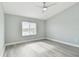Spacious bedroom with ceiling fan and grey flooring at 1709 Edgewater Ln, Palmetto, FL 34221
