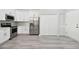 Bright kitchen with white cabinets, stainless steel appliances, and grey flooring at 1709 Edgewater Ln, Palmetto, FL 34221