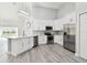 Bright kitchen with white cabinets, stainless steel appliances, and an island at 1709 Edgewater Ln, Palmetto, FL 34221