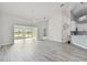 Open living room showcasing gray flooring and a shiplap feature wall at 1709 Edgewater Ln, Palmetto, FL 34221
