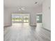 Spacious living area with gray vinyl flooring, and access to a sunroom at 1709 Edgewater Ln, Palmetto, FL 34221