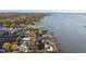 Aerial view of waterfront homes and properties with a city skyline in the background at 1836 Venetian Point Dr, Clearwater, FL 33755