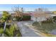 Single story home with a large driveway and backyard at 1836 Venetian Point Dr, Clearwater, FL 33755