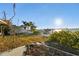 Landscaped backyard with wooden deck, offering scenic waterfront views at 1836 Venetian Point Dr, Clearwater, FL 33755