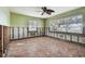 Needs renovation, bedroom with tiled floors and ceiling fan at 1836 Venetian Point Dr, Clearwater, FL 33755