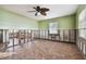 Needs renovation, bedroom with tiled floors and ceiling fan at 1836 Venetian Point Dr, Clearwater, FL 33755