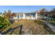Charming bungalow with a terracotta roof and lush landscaping at 1836 Venetian Point Dr, Clearwater, FL 33755