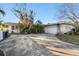 Ranch style home with carport and mature landscaping at 1836 Venetian Point Dr, Clearwater, FL 33755