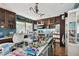 Kitchen with island, wooden cabinets, and a view to outside at 1836 Venetian Point Dr, Clearwater, FL 33755