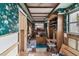 Office with floral wallpaper, built-in shelving, and hardwood accents at 1836 Venetian Point Dr, Clearwater, FL 33755