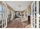 Bright sunroom with tile floors and French doors at 1836 Venetian Point Dr, Clearwater, FL 33755