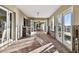 Sunroom with tiled floor and glass doors leading to backyard at 1836 Venetian Point Dr, Clearwater, FL 33755