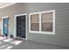 Front entrance with a metal door and gray siding at 2511 Dolly Bay Dr # 303, Palm Harbor, FL 34684